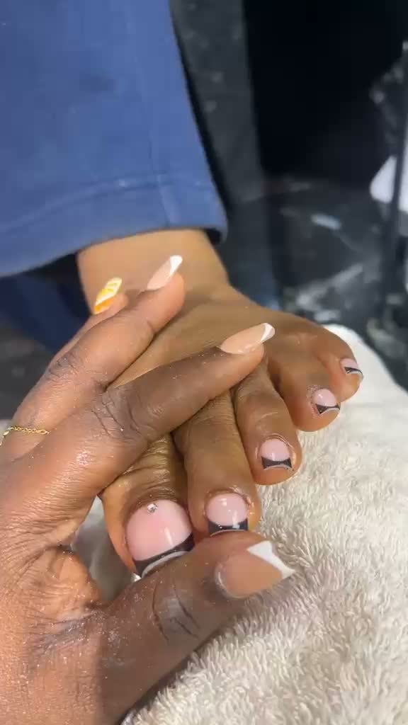 French tip pedicure with black and white details